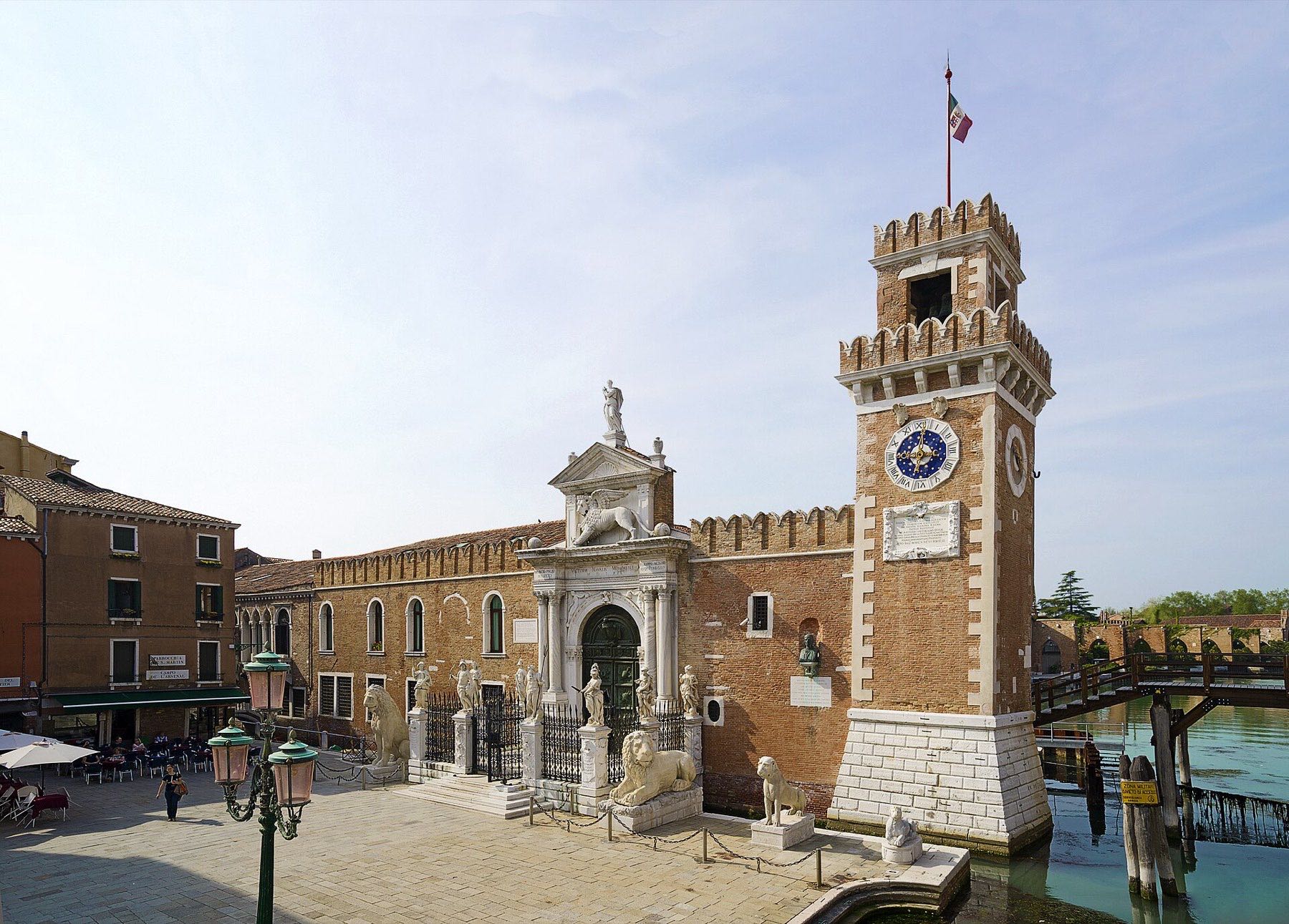 The monumental land gate of the Arsenale di Venezia, guarded by stone lions beside the canal entrance