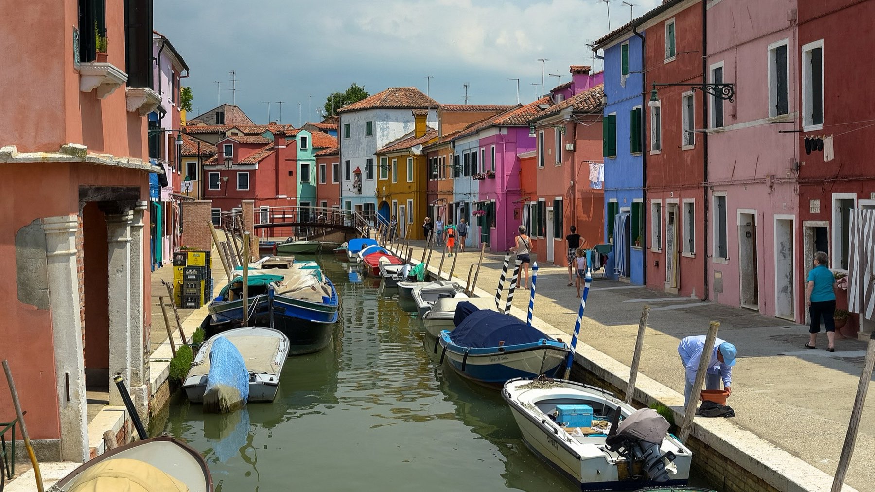 Brightly painted fishermen's houses lining a quiet canal on the island of Burano