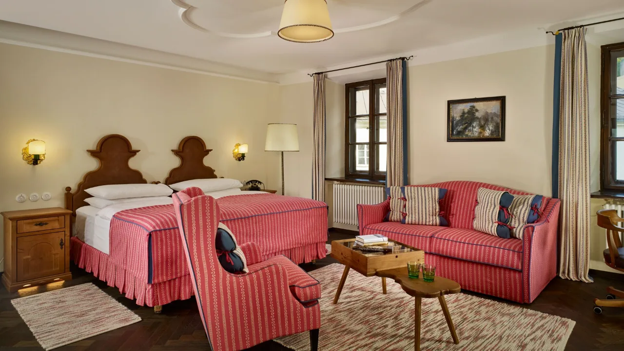 King bedroom in a One-Bedroom Suite at Hotel Goldener Hirsch