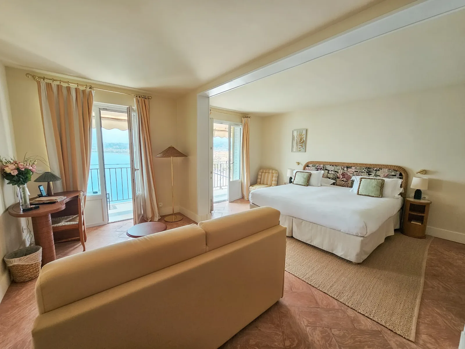 King bedroom and sitting area in Suite Baie des Anges at Hôtel La Pérouse