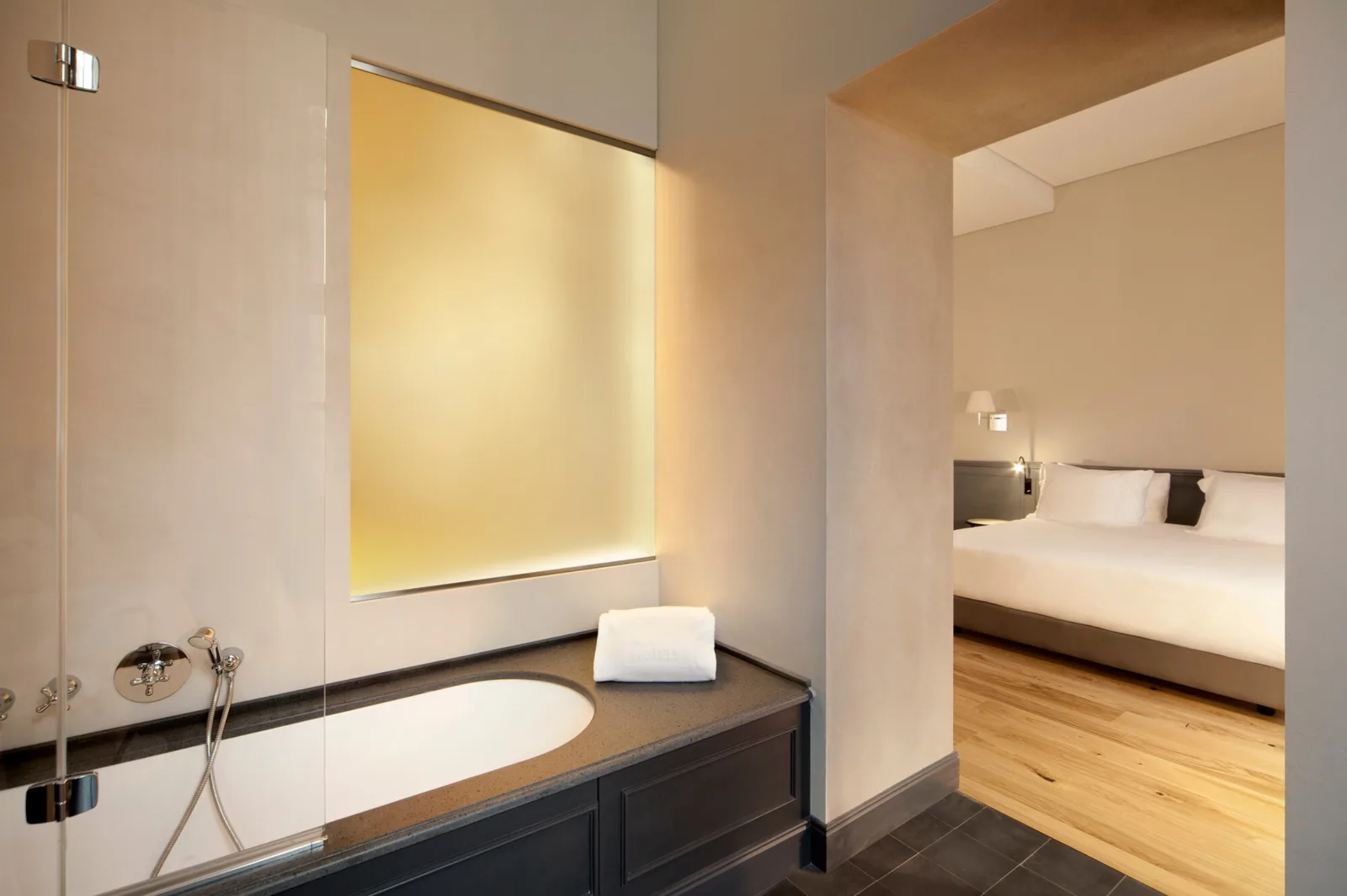 Bedroom and bath in the Suite with View at NH Collection Torino Piazza Carlina